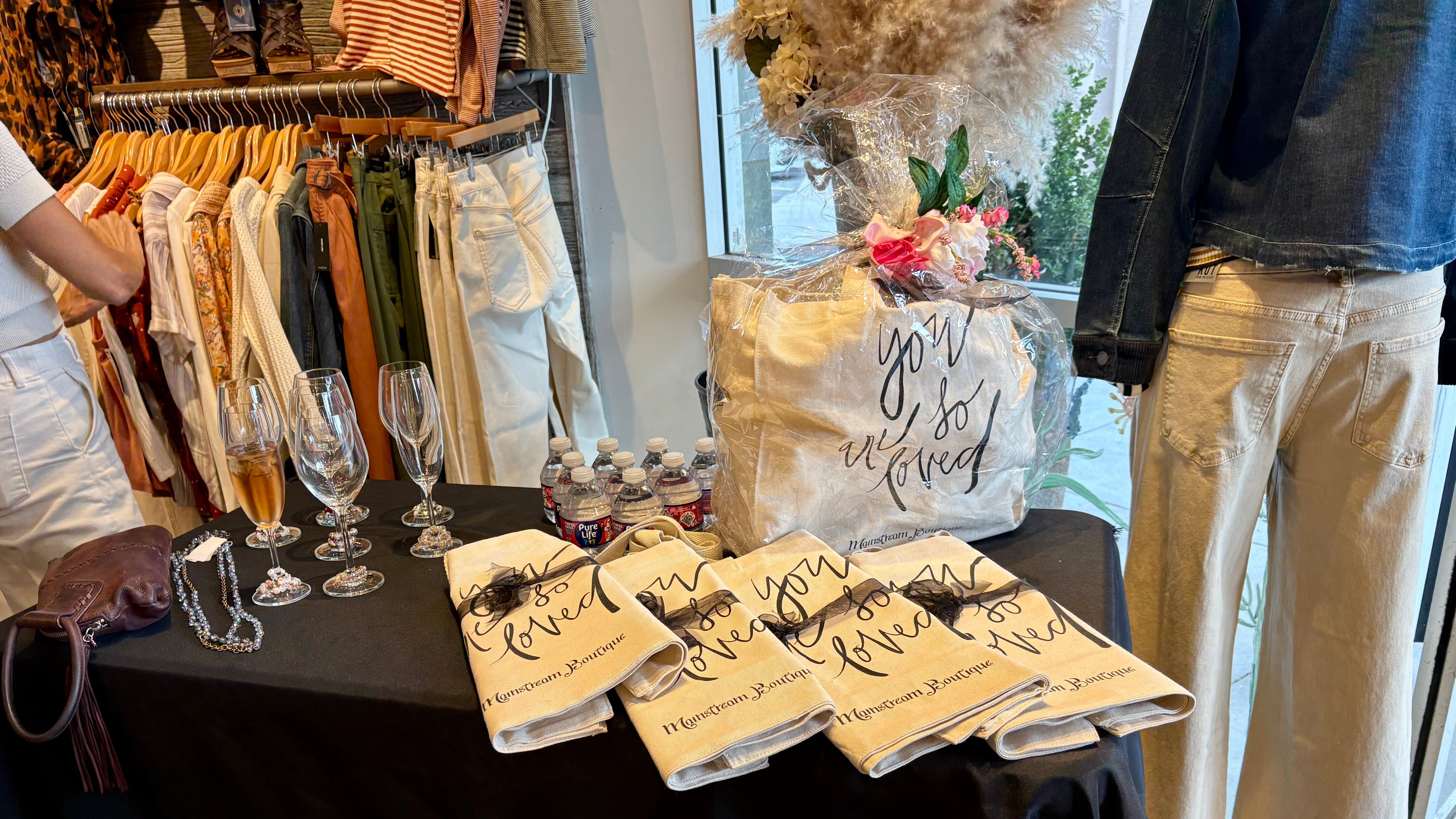 Table with printed items and glasses in a store setting
